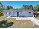 Charming single-story home featuring a well-maintained front yard and a bright blue front door at 2480 Alamanda Ave, Deltona, FL 32738