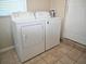 Bright laundry area features tile floors and newer washer and dryer at 2480 Alamanda Ave, Deltona, FL 32738
