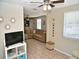 Spacious open-concept living room featuring tile flooring, ceiling fan, and lots of natural light at 2480 Alamanda Ave, Deltona, FL 32738