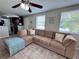 Spacious living room features a ceiling fan and bright windows, perfect for relaxation and entertaining at 2480 Alamanda Ave, Deltona, FL 32738