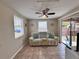 Cozy living room with a comfortable couch, natural light, and access to the backyard at 2480 Alamanda Ave, Deltona, FL 32738