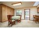 Cozy dining area with a table set for four and adjacent bar seating and view of the sunroom at 2713 Lime Tree Dr, Edgewater, FL 32141
