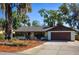 Lovely home featuring a manicured front yard and an attached garage at 2713 Lime Tree Dr, Edgewater, FL 32141