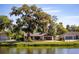 Scenic view of the home's exterior complemented by a tranquil waterfront setting at 2713 Lime Tree Dr, Edgewater, FL 32141