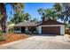 Charming single-story home with a well-maintained lawn and a cozy front porch at 2713 Lime Tree Dr, Edgewater, FL 32141