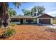 Inviting front yard with mature trees and beautiful landscaping enhancing this lovely home at 2713 Lime Tree Dr, Edgewater, FL 32141