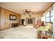 Inviting living room with brick fireplace, paneled walls, carpet and comfortable seating at 2713 Lime Tree Dr, Edgewater, FL 32141
