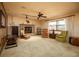 Comfortable living room featuring a brick fireplace, paneled walls, carpet, and furniture at 2713 Lime Tree Dr, Edgewater, FL 32141