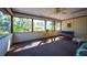 Bright sunroom with large windows, a swing, and comfortable seating with natural light at 2713 Lime Tree Dr, Edgewater, FL 32141