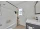 Well-lit bathroom with a shower-tub combo, modern vanity, and a neutral color scheme at 2732 Lion Heart Rd, Winter Park, FL 32792