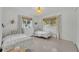 Shared bedroom with twin beds, bright natural light, white dresser, and matching decor at 2732 Lion Heart Rd, Winter Park, FL 32792