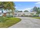 Charming single-story home with a spacious driveway, green lawn, and a lovely pink front door at 2732 Lion Heart Rd, Winter Park, FL 32792
