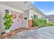 Close-up of the home's pink double front doors, brick entryway, and a lush green plant at 2732 Lion Heart Rd, Winter Park, FL 32792