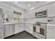 Bright kitchen with white subway tile, stainless steel appliances, white cabinetry and black hexagon tile at 2732 Lion Heart Rd, Winter Park, FL 32792