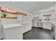 Modern kitchen features stainless appliances, white cabinetry, sleek countertops, and black tiled floors at 2732 Lion Heart Rd, Winter Park, FL 32792