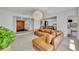 Spacious open-concept living area with a brown sectional couch, wooden accents, and views into other rooms at 2732 Lion Heart Rd, Winter Park, FL 32792