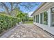 Outdoor patio with pavers, lush greenery, seating area, and serene backyard view at 2732 Lion Heart Rd, Winter Park, FL 32792