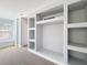 Neutral bonus room features custom built-in shelving, natural light from the window and neutral carpet at 2816 Northampton Ave, Orlando, FL 32828