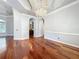 Open living room with hardwood floors, a view of the kitchen, and decorative lighting at 2816 Northampton Ave, Orlando, FL 32828