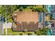 Aerial view of the house showcasing the rooftop, screened-in pool, and surrounding landscape in a tranquil setting at 2839 Drifting Lilly Loop, Kissimmee, FL 34747