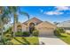 Charming single-story home featuring lush landscaping, a well-manicured lawn, and a two-car garage at 2839 Drifting Lilly Loop, Kissimmee, FL 34747