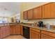 This beautiful kitchen features wood cabinets, granite countertops, and modern appliances at 2839 Drifting Lilly Loop, Kissimmee, FL 34747