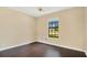 This vacant bedroom features hardwood floors, a ceiling fan, and a window with natural light at 2910 S Whisperbay Ct, Oviedo, FL 32765