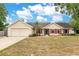 Charming single-story home with red shutters, a well-manicured lawn, and an attached two-car garage at 2910 S Whisperbay Ct, Oviedo, FL 32765