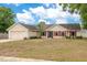 Charming single-story home with red shutters, a well-manicured lawn, and an attached two-car garage at 2910 S Whisperbay Ct, Oviedo, FL 32765