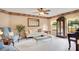 Cozy living room is decorated with a sofa, chairs, glass coffee table, and decorative wall art at 2910 S Whisperbay Ct, Oviedo, FL 32765