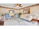 Cozy living room featuring a ceiling fan, ample seating, and a neutral color palette at 2910 S Whisperbay Ct, Oviedo, FL 32765