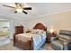 Comfortable main bedroom with traditional furniture, ceiling fan, and ensuite bath at 2910 S Whisperbay Ct, Oviedo, FL 32765