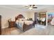 Spacious main bedroom features a decorative bed frame and sliding door access to the patio at 2910 S Whisperbay Ct, Oviedo, FL 32765