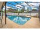 Inviting in-ground pool and jacuzzi surrounded by a screened enclosure, offers a private retreat at 2910 S Whisperbay Ct, Oviedo, FL 32765