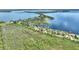 Gorgeous aerial showcasing a waterfront house with mature trees and picturesque lake views at 29150 Beauclaire Dr, Tavares, FL 32778