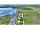 Aerial view of a waterfront home with lush foliage and serine lake views from above at 29150 Beauclaire Dr, Tavares, FL 32778