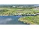Beautiful aerial view of a waterfront home with dock on a serene lake surrounded by lush greenery at 29150 Beauclaire Dr, Tavares, FL 32778
