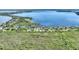 Breathtaking aerial view of a lakeside home nestled among lush greenery, offering stunning waterfront views and serene privacy at 29150 Beauclaire Dr, Tavares, FL 32778