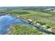 Waterfront home with boat dock surrounded by lush greenery and serene lake views at 29150 Beauclaire Dr, Tavares, FL 32778