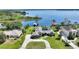Stunning lakefront property boasting a custom home with a screened-in pool, a private dock, and mature landscaping at 29150 Beauclaire Dr, Tavares, FL 32778