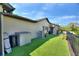 A tidy backyard features artificial turf, a small storage shed, and secure fencing for privacy and a manicured appearance at 29150 Beauclaire Dr, Tavares, FL 32778