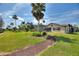 An attractive backyard featuring lush green grass, a screened-in patio, and elegant landscaping provides the ideal setting at 29150 Beauclaire Dr, Tavares, FL 32778