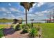 Expansive waterfront property with lush lawn, mature landscaping, and a private dock featuring a boat lift at 29150 Beauclaire Dr, Tavares, FL 32778