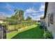 Fenced backyard area with manicured artificial turf and tasteful garden boxes provides a clean and inviting outdoor space at 29150 Beauclaire Dr, Tavares, FL 32778