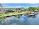 Stunning lake view with private dock and boat house, perfect for waterfront living and enjoying outdoor recreation at 29150 Beauclaire Dr, Tavares, FL 32778