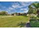 Beautiful single-story home with a well-manicured lawn, charming front porch, and appealing exterior siding on a sunny day at 29150 Beauclaire Dr, Tavares, FL 32778