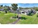 Charming home showcasing a well-manicured lawn, mature palm trees, and a screened-in pool, perfect for outdoor enjoyment at 29150 Beauclaire Dr, Tavares, FL 32778