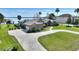 Lovely home featuring a circular driveway, attached garage, and a well-kept lawn at 29150 Beauclaire Dr, Tavares, FL 32778