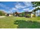 Beautiful single-story home with a well-manicured lawn, charming front porch, and appealing exterior siding on a sunny day at 29150 Beauclaire Dr, Tavares, FL 32778