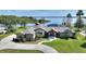 Stunning lakefront home with lush landscaping, circular driveway, and beautiful waterfront views at 29150 Beauclaire Dr, Tavares, FL 32778